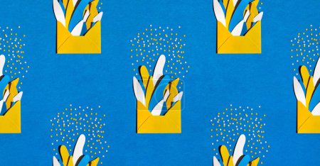 Photo for Creative composition made with yellow paper envelopes, abstract colored plants and confetti on a blue background. Celebration pattern background. Flat lay. Banner. Minimal party concept - Royalty Free Image