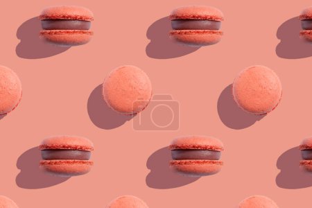 Coral color macaroons cookies on a coral background