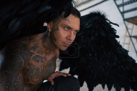 Photo for Man portrait. Close up portrait of handsome male angel. Guy with tattoo. hot man in leather . man with collar and whip. Angle with dark wings - Royalty Free Image