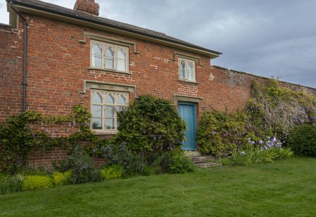 Photo for Red brick cottage in the walled garden of Croft Castle, Yarpole, Herefordshire, England, UK - Royalty Free Image