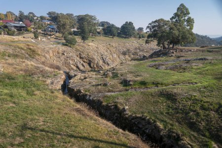 A historic mining tailrace measuring 8 feet deep and 450 yards long in the rural town of Beechworth, Victoria, Australia