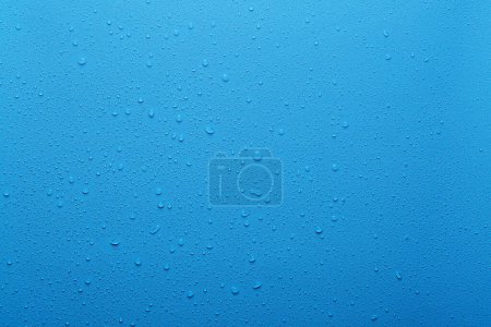 Water drops on blue background and plastic surface