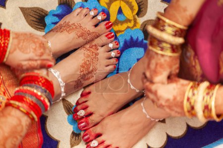 Foto de Concepto de boda india. Hermosos pies de dos mujeres en una boda india, decorado con auspicioso color rojo (Alta), tobilleras, y anillos de dedo del pie. - Imagen libre de derechos