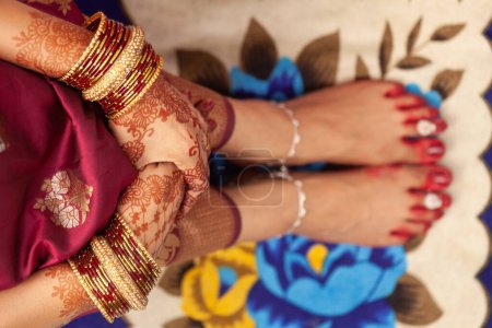 Téléchargez les photos : Concept de mariage indien bengali. Beaux pieds d'une mariée indienne, décorés avec une couleur rouge de bon augure (Alta), des bracelets de cheville et des anneaux d'orteils. - en image libre de droit
