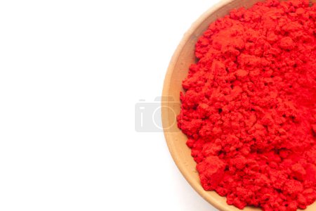 Top view of Earthen pot filled with Auspicious Red colored sindoor isolated on white.