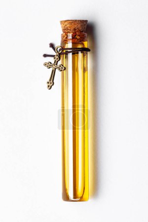 Top-down view of a glass vial containing light yellow color essential oil for cosmetics and natural medicine.