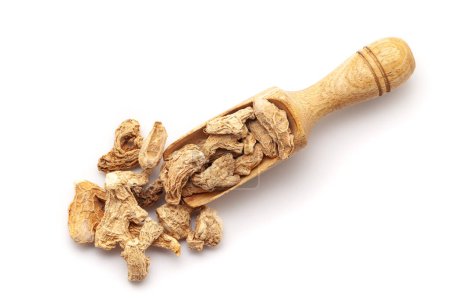 Top view of Organic dry Ginger root (Zingiber officinale) or sonth, in a wooden scoop. Isolated on a white background.