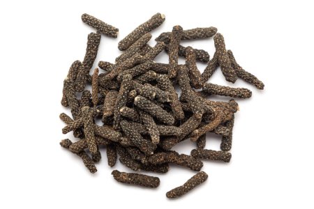 A pile of Dry Organic Long pepper (Piper longum) fruit, isolated on a white background. Top view