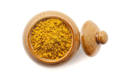 Top view of Organic digestive powder called "Buknu" a mixture of Indian ayurvedic herbs and spices, in a ceramic jar. Isolated on a white background.