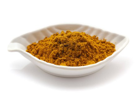Front View of Organic digestive powder called "Buknu" a mixture of Indian ayurvedic herbs and spices, in a white ceramic bowl. Isolated on a white background.