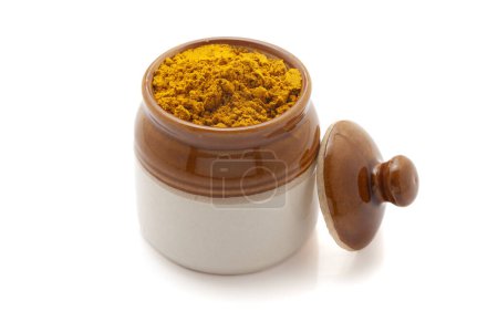 Front view of Organic digestive powder called "Buknu" a mixture of Indian ayurvedic herbs and spices, in a ceramic jar. Isolated on a white background.