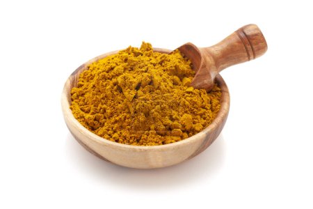 Top View of Organic digestive powder called "Buknu" a mixture of Indian ayurvedic herbs and spices, in a wooden bowl with a wooden scoop. Isolated on a white background.