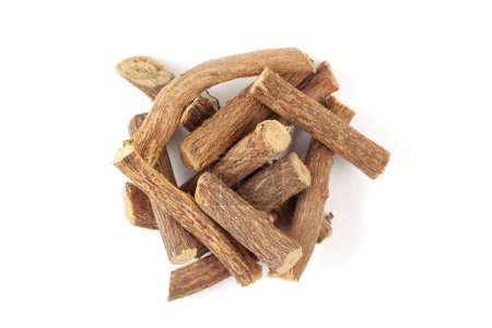 A pile of Dry Organic Liquorice or Mulethi (Glycyrrhiza glabra) roots, isolated on a white background. Top view