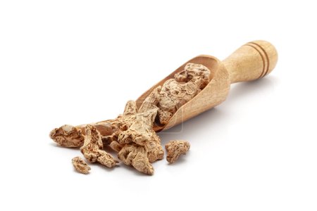 Front view of a wooden scoop filled with Organic Dry Ginger root (Zingiber officinale) or sonth. Isolated on a white background.