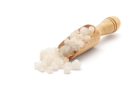 Front view of a wooden scoop filled with Organic coarse sea Salt (sodium chloride). Isolated on a white background.