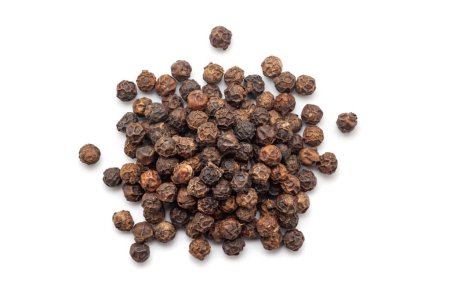 A pile of Dry Organic Black pepper (Piper nigrum), isolated on a white background. Top view