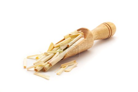 Front view of a wooden scoop filled with Organic lemongrass (Cymbopogon flexuosus). Isolated on a white background.