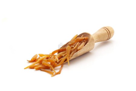 Front view of a wooden scoop filled with dry Organic Shatavari (Asparagus racemosus) roots. Isolated on a white background.