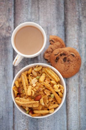 Close-Up of crunchy Indian mixture snacks with hot tea or Coffee time and handmade cookies (biscuits). 
