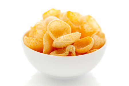 Close up of Cheese Puff Snacks cream color, Popular Ready to eat crunchy and puffed snacks cheesy salty pale-yellow color over white background
