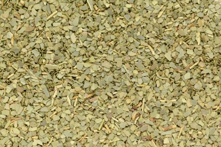 Organic dry Indian bay leaf (Cinnamomum tamala) in tea cut size. Macro close up background texture. Top view.