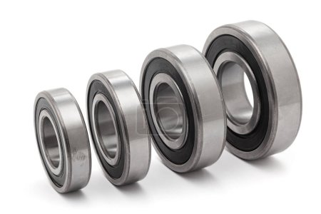 A collection of assorted tapered roller bearings of various sizes, isolated on a white background.