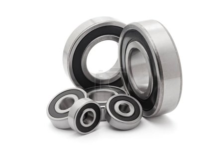 A collection of assorted tapered roller bearings of various sizes, isolated on a white background.