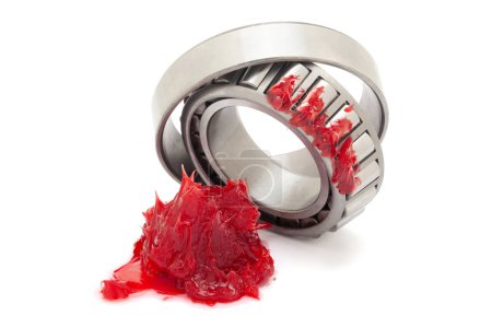 A tapered roller bearing with red lithium grease (Machinery Lubrication). Isolated on a white background. Front view.