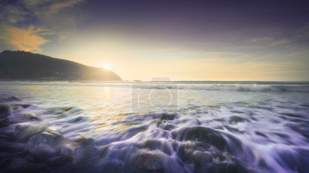 Photo for Waves in rough sea on the rocks of Baratti beach. Piombino, Alta Maremma, Tuscany region, Italy - Royalty Free Image