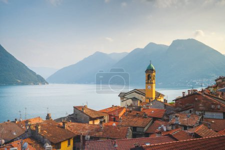 Photo for Colonno in Lake Como. View of the bell tower above the roofs of the village. Italy, Europe. - Royalty Free Image