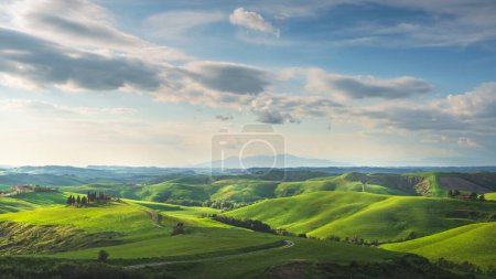 Photo for Countryside landscape, rolling hills, rural road, and green fieldse at sunset. Volterra, Tuscany region, Italy, Europe - Royalty Free Image