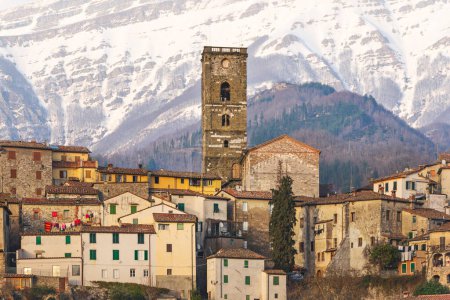 Coreglia Antelminelli, beautiful village and snowy Apennines mountains in the background in winter. Garfagnana, Tuscany, Italy Europe