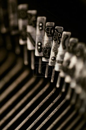 Photo for Closeup of old typewriter plates strikers strykers with letters and symbols for typing. Shallow depth of field - Royalty Free Image