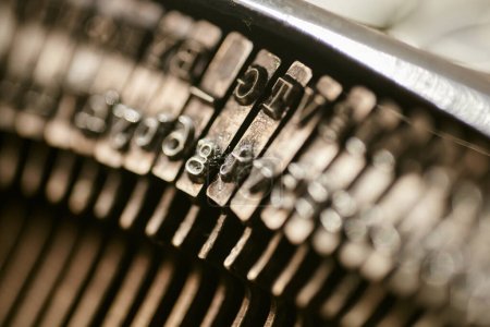 Photo for Closeup of old typewriter plates strikers strykers with letters and symbols for typing. Shallow depth of field - Royalty Free Image