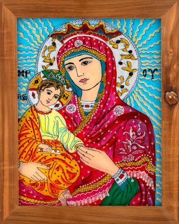 Photo for Icon painted on reverse glass in the naive orthodox style of Eastern Europe depicting Virgin Mary and baby Jesus. Framed icon. - Royalty Free Image
