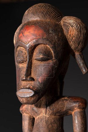 Close up of a wooden Senufo Male figure from Ivory Coast. Tribal African art, showcasing masterful craftsmanship and spiritual symbolism.
