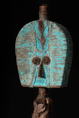 Kota reliquary figure from Gabon, isolated on a black background. Tribal African art, showcasing masterful craftsmanship and spiritual symbolism.