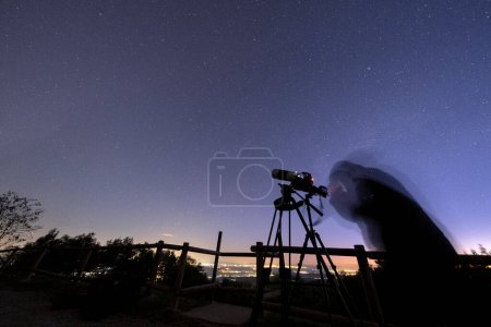 Astronom mit Kamera fotografiert den Nachthimmel.