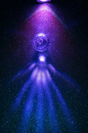 On a gradient background, a vertical diffused gradient beam of lilac and blue light