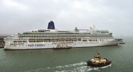 Photo for Port of Southampton, England - 30th September 2021:P&O Aurora taking on fuel in the grey mist - Royalty Free Image