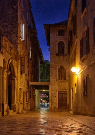 Photo for Old street in Porec town illuminated by lamps at the evening, Croatia, Europe - Royalty Free Image