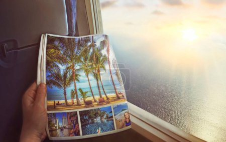 Photo for Airplane window with beautiful views of turquoise clear sea, palm trees and bright sunrise.Woman sitting by the window on an airplane and looking at an advertisement page in a magazine.Dreams and travel concept art - Royalty Free Image