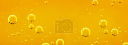 Foto de Líquido dorado con burbujas de aire u oxígeno sobre fondo de aceite para proyectos, aceite, miel, cerveza, jugo, champús. Fondo de petróleo. - Imagen libre de derechos