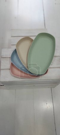 Photo for Colorful plates on wooden crate, close up view - Royalty Free Image