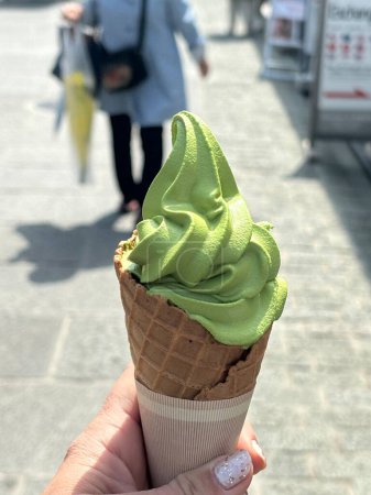 Photo for Ice cream in waffle cone on the background of a green leaf. - Royalty Free Image