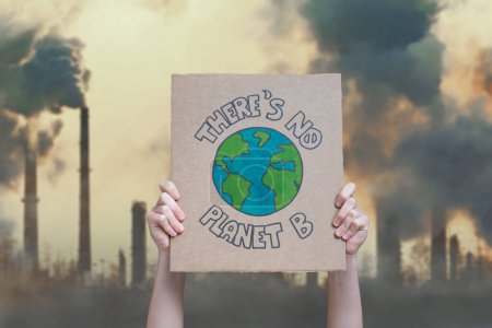 Climate change manifestation poster on an industrial fossil fuel burning background: there is no planet b