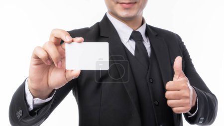 Foto de Hombre de negocios usar un traje con tarjeta de visita vacía, tarjeta de crédito o tarjeta de nombre y dar un pulgar hacia arriba la mano para banner de publicidad aislado en el fondo blanco con el concepto de negocio espacio de copia - Imagen libre de derechos