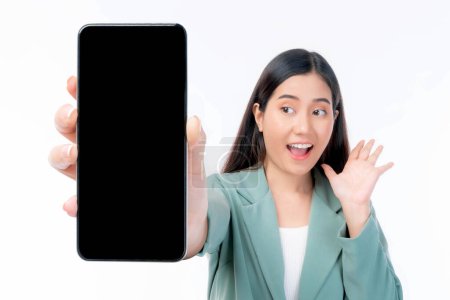 Foto de Beautiful Asian young woman ,Excited surprised girl showing smart phone with blank screen , black screen for Mobile App Advertising isolated on white background , smart phone display Mock Up Image - Imagen libre de derechos