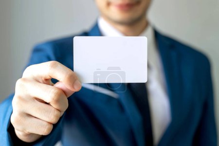 Foto de Hombre de negocios sosteniendo y mostrando tarjeta de visita vacía o tarjeta de nombre - concepto de negocio - Imagen libre de derechos