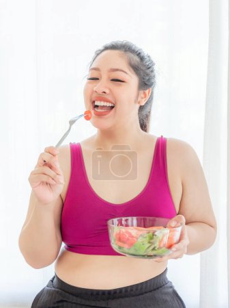 Photo for Overweight asian plump female ,fat women , Fat girl , Chubby, eating vegetable salad - lifestyle Woman diet weight loss overweight problem concept - Royalty Free Image